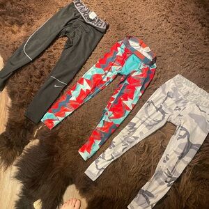 Nike dri fit compression pants. 4 pairs Black, Red, and white camo, gray